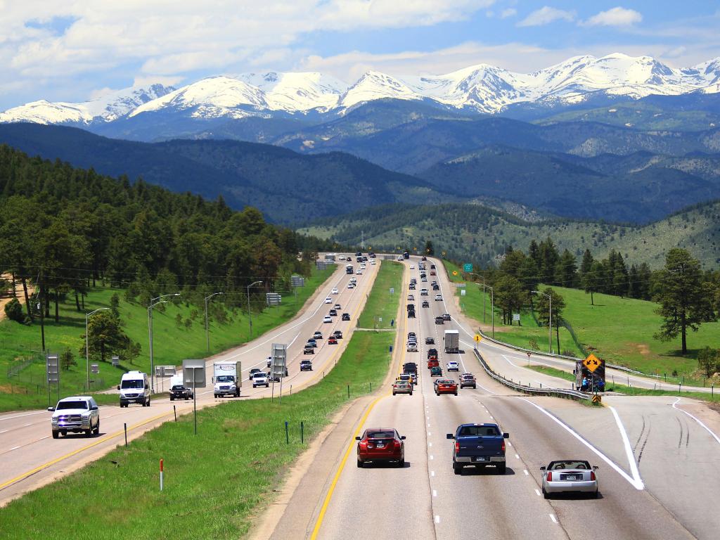 Shot of the wide interstate (I-70) leading to Vail through the snow-capped Rocky Mountains, Colorado