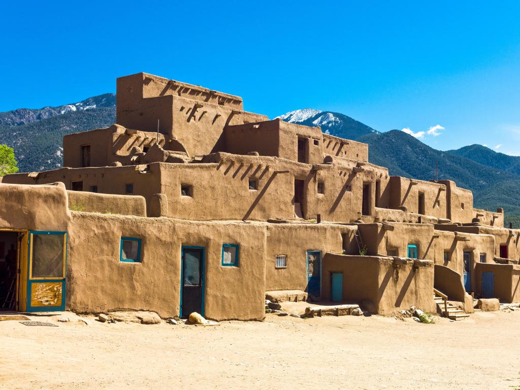 Taos, New Mexico, at the native pueblo dwellings against a blue sky.