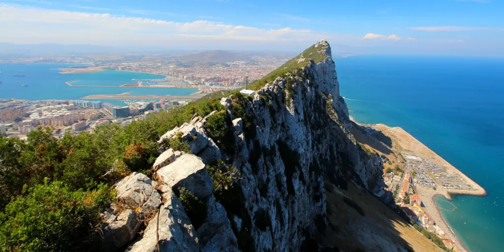 The Rock of Gibraltar stands tall beside the Mediterranean Sea in southern Spain