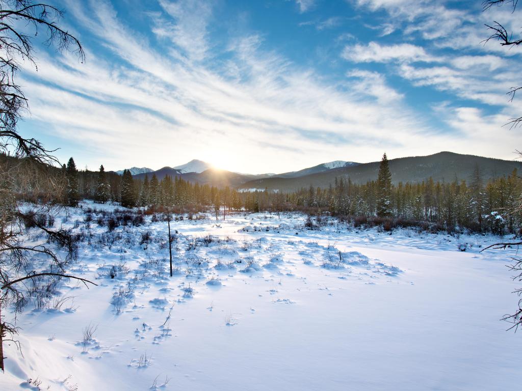 Sun setting in the Winter over Byers Peak, Winter Park, Colorado.