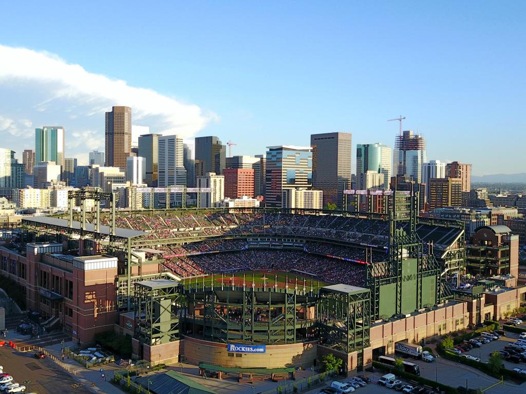 Aerial view of the Coors Field stadium and the Denver city skyline behind it