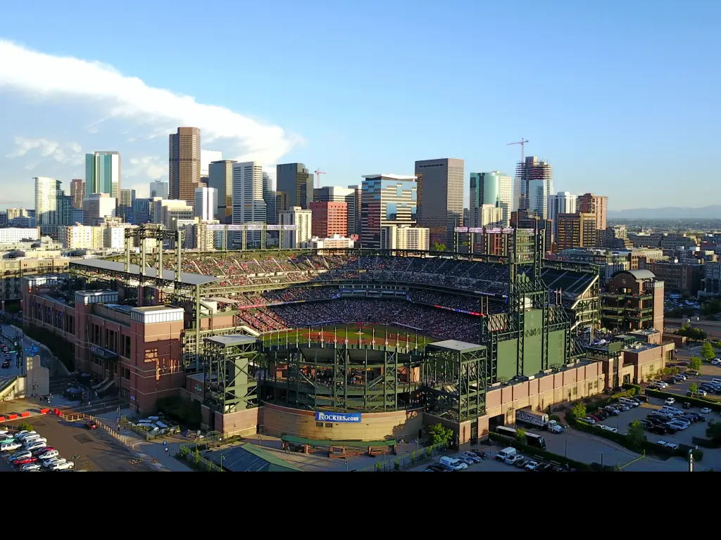 Aerial view of the Coors Field stadium and the Denver city skyline behind it