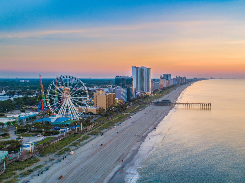 Myrtle Beach, South Carolina, USA taken as an aerial view of the city skyline against the beach, with a calm sea and taken at sunset.