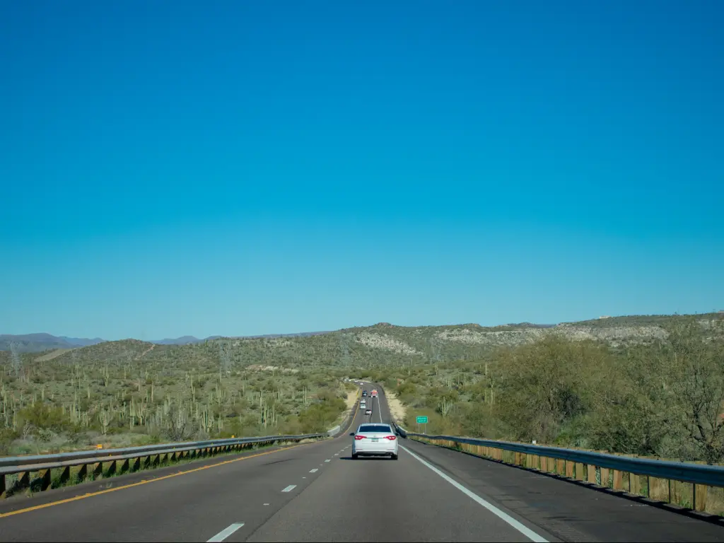 Interstate 17, surrounded by saguaro cactus on a clear sunny day in Pheonix, Arizona.