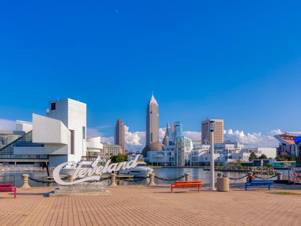 The skyline of Cleveland with Key Bank, Rock and Roll Hall of Fame, and Science Center Building in a cloudy blue sky morning