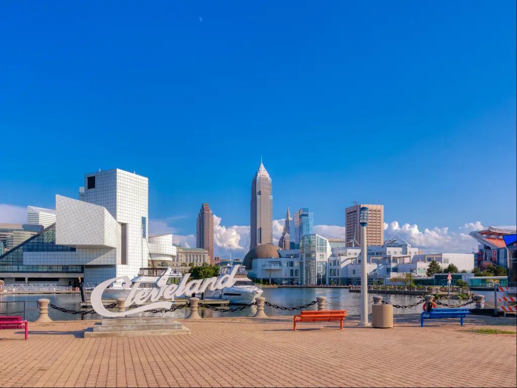 The skyline of Cleveland with Key Bank, Rock and Roll Hall of Fame, and Science Center Building in a cloudy blue sky morning