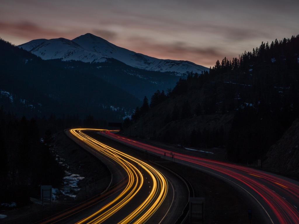 I-70 running through the Rocky Mountains near Silver Plume, Colorado. Long exposure shot at night with taillights  
