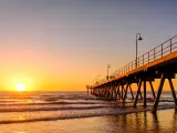 Glenelg Beach Jetty during sunset with waves hitting the shore