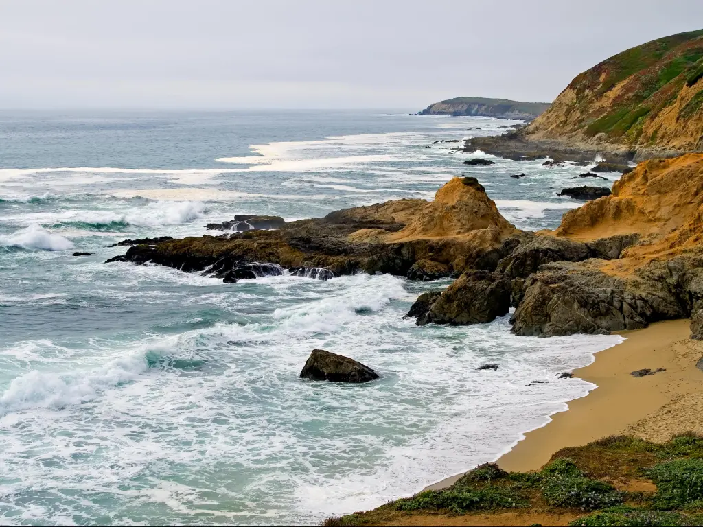 Bodega Bay, California, USA with a view of the coast and rocky cliffs.