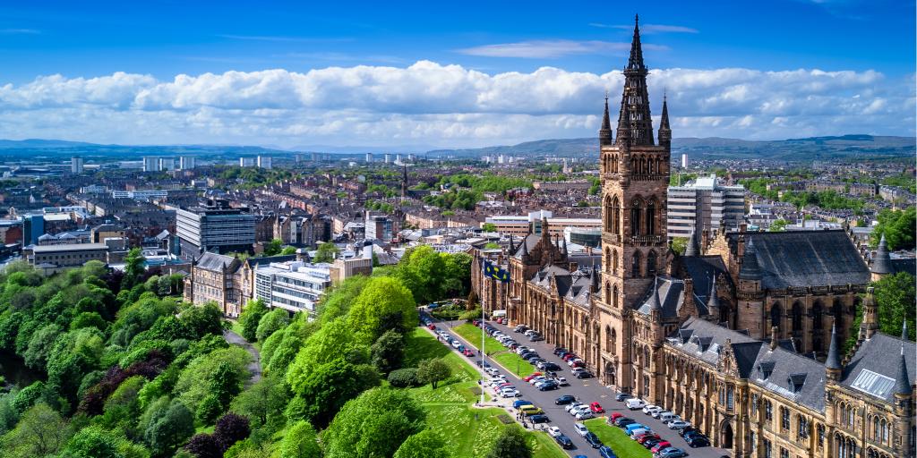 Aerial view of Glasgow University with a blue sky and the city in the background