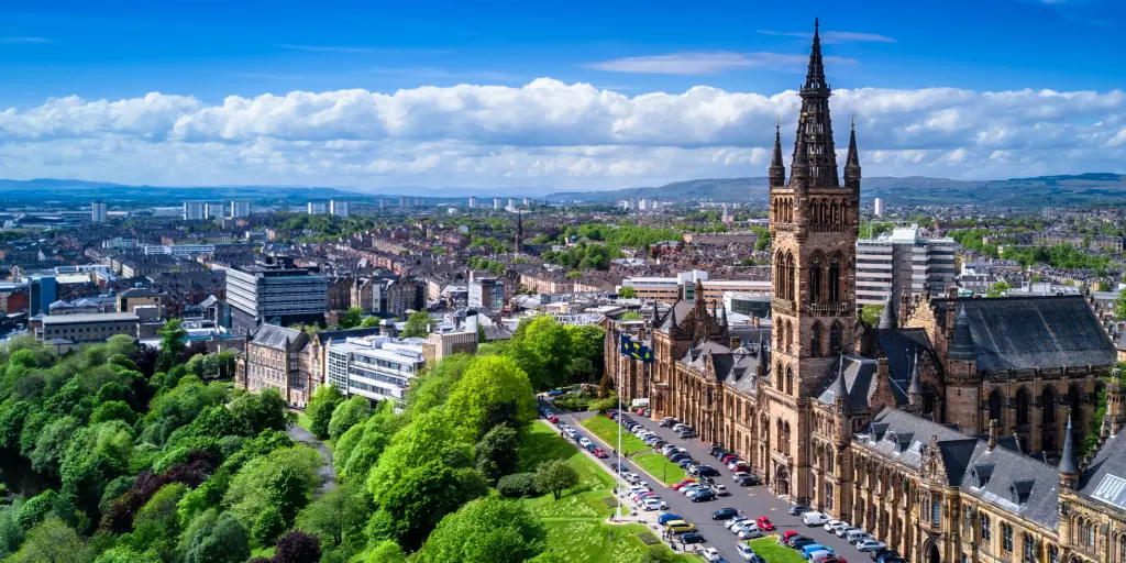 Aerial view of Glasgow University with a blue sky and the city in the background