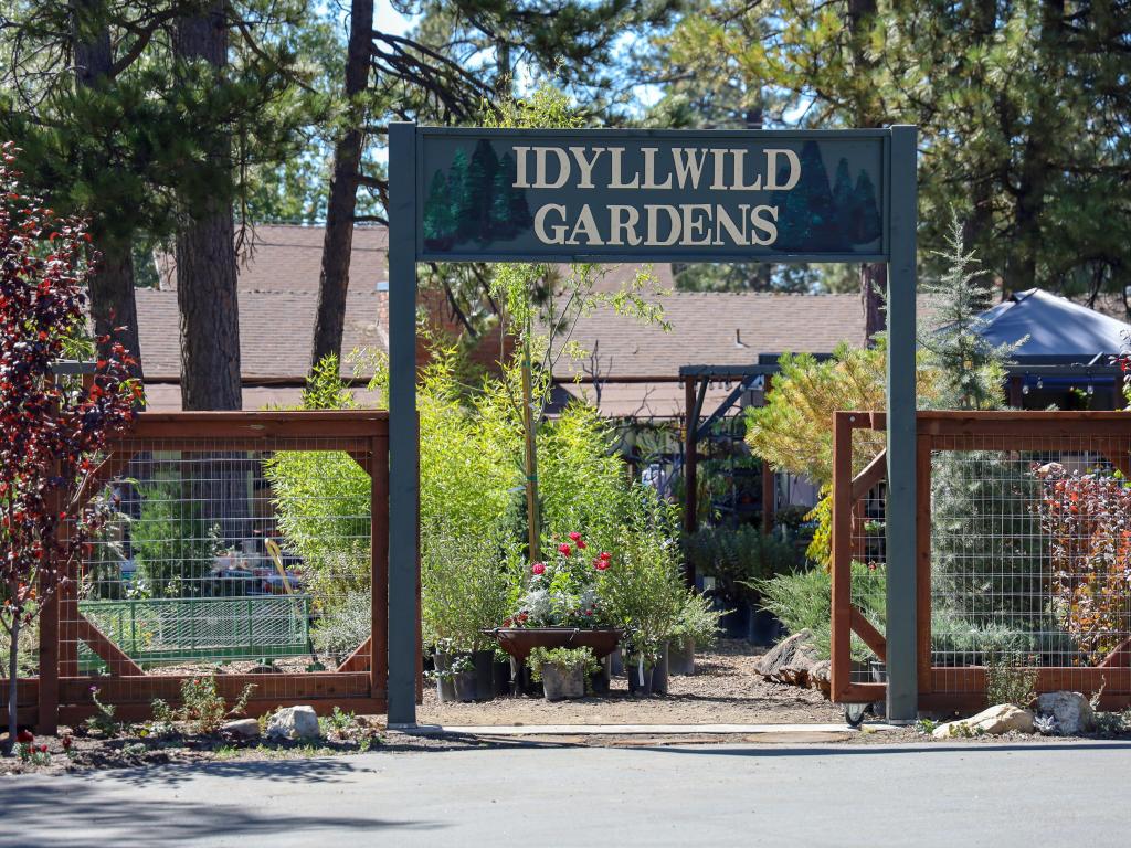 Idyllwild Nature Center, Mount San Jacinto State Park, California, USA with a view of The Idyllwild Gardens sign at the entrance.