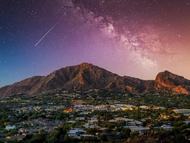 Camelback Mountain view at night with Milky Way and a shooting star in the background