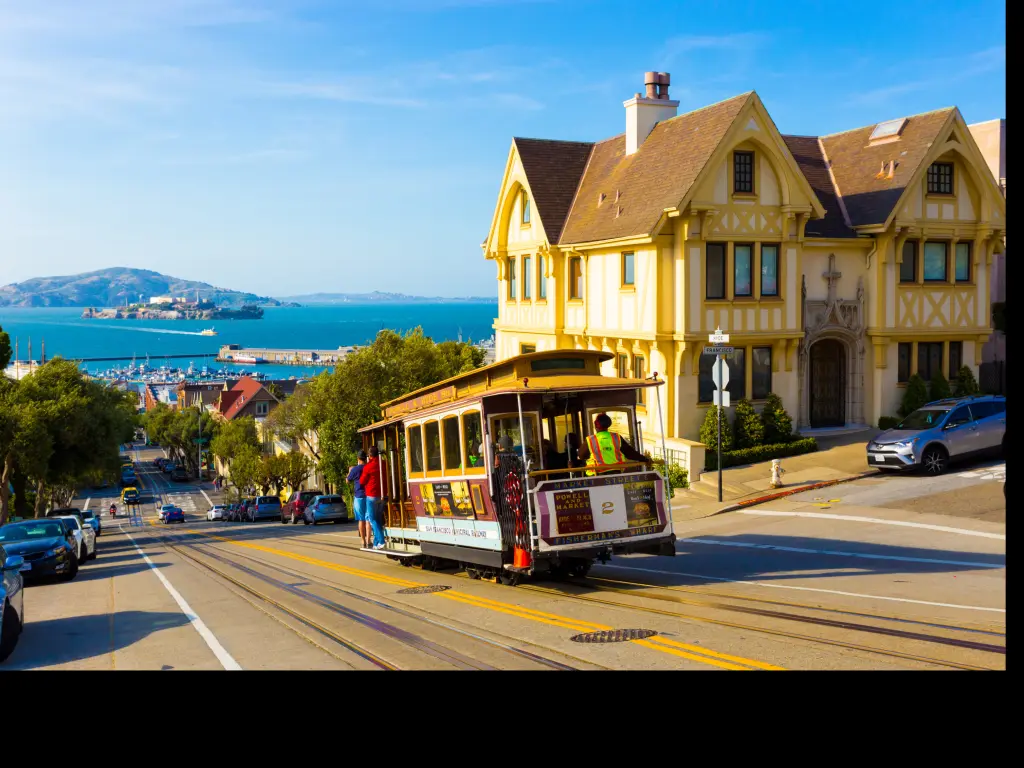 San Francisco cable car tram going downhill with Alcatraz in the background