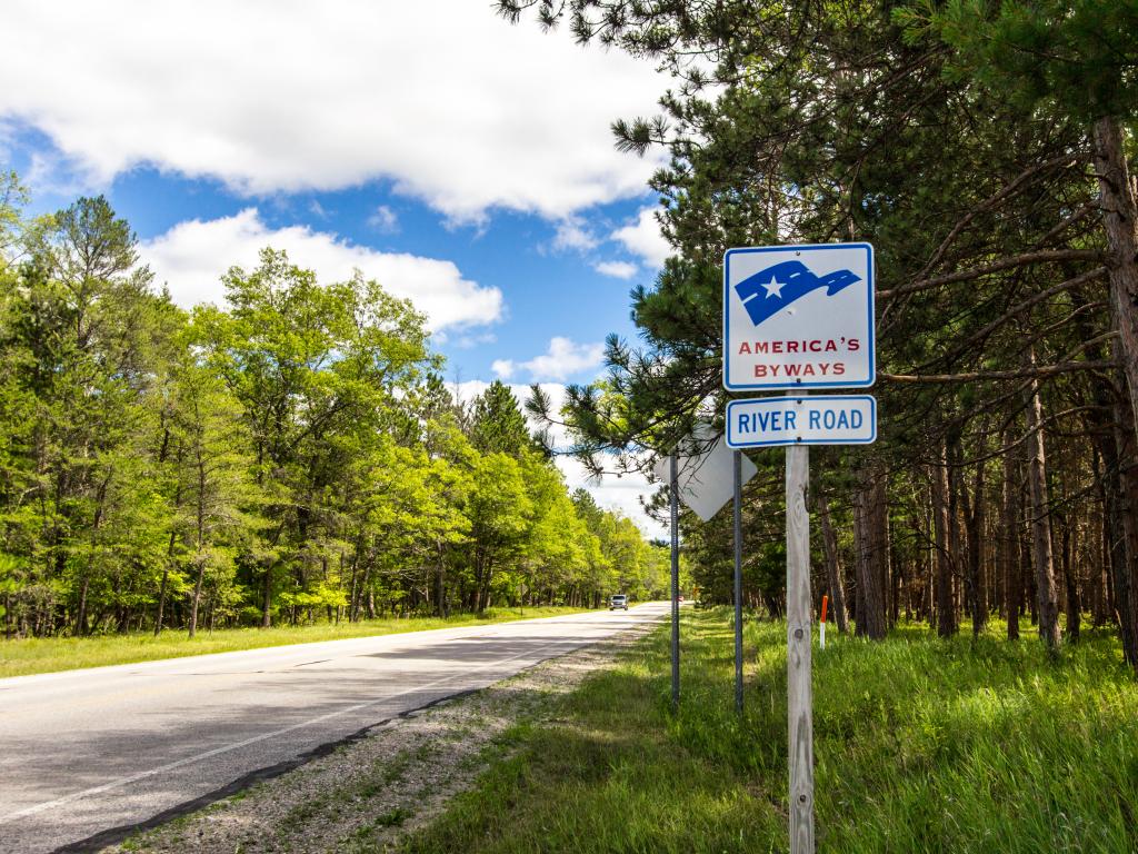 The River Road America's byway signpost at the side of the highway along Manistee National Forest on a cloudy day