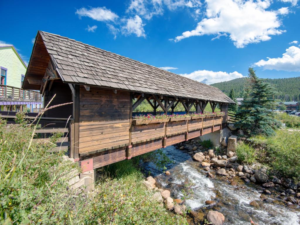 Close up view of the historic wooden covered bridge crossing over Middle Boulder Creek in Nederland Colorado