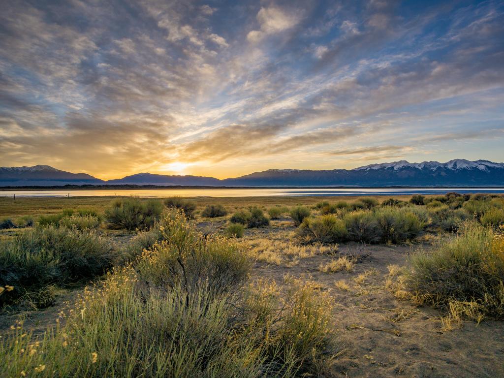 A sweeping vista encompassing the grandeur of Great Sand Dunes National Park, visible in the distance.