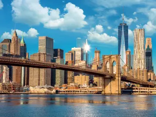 Sunny day over the Brooklyn Bridge with the skyscrapers of Manhattan in the background