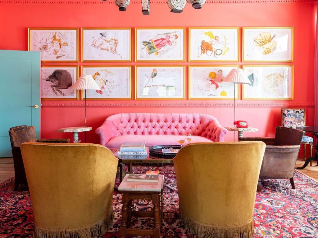 Bright pink furniture and walls, and colorful decoration at bar at Bradford House, Oklahoma City