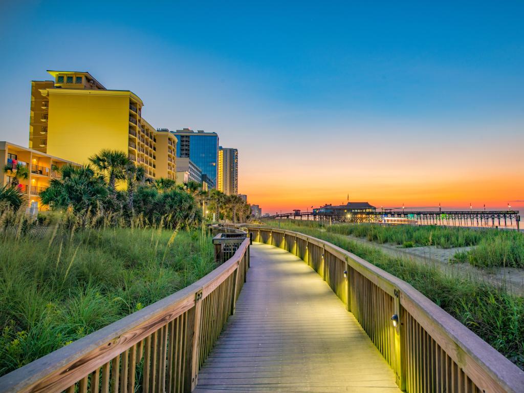 Myrtle Beach, South Carolina, USA taken with a view of the iconic boardwalk at sunrise.