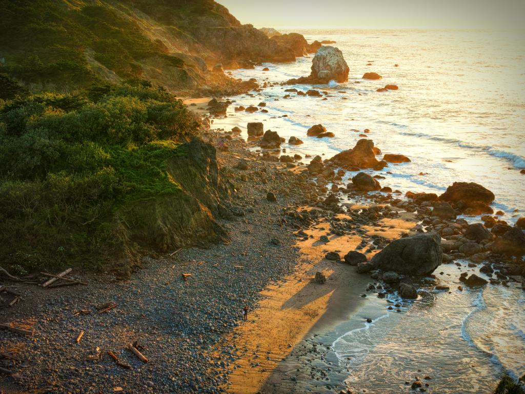 A typical outlook on the Pacific Coast Highway, a view onto the ocean and rugged rocks during sunset