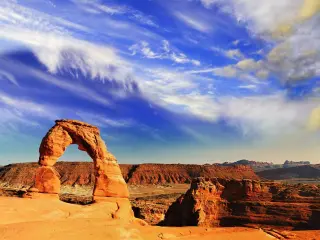 Famous arch in Arches National Park on a dramatically cloudy day
