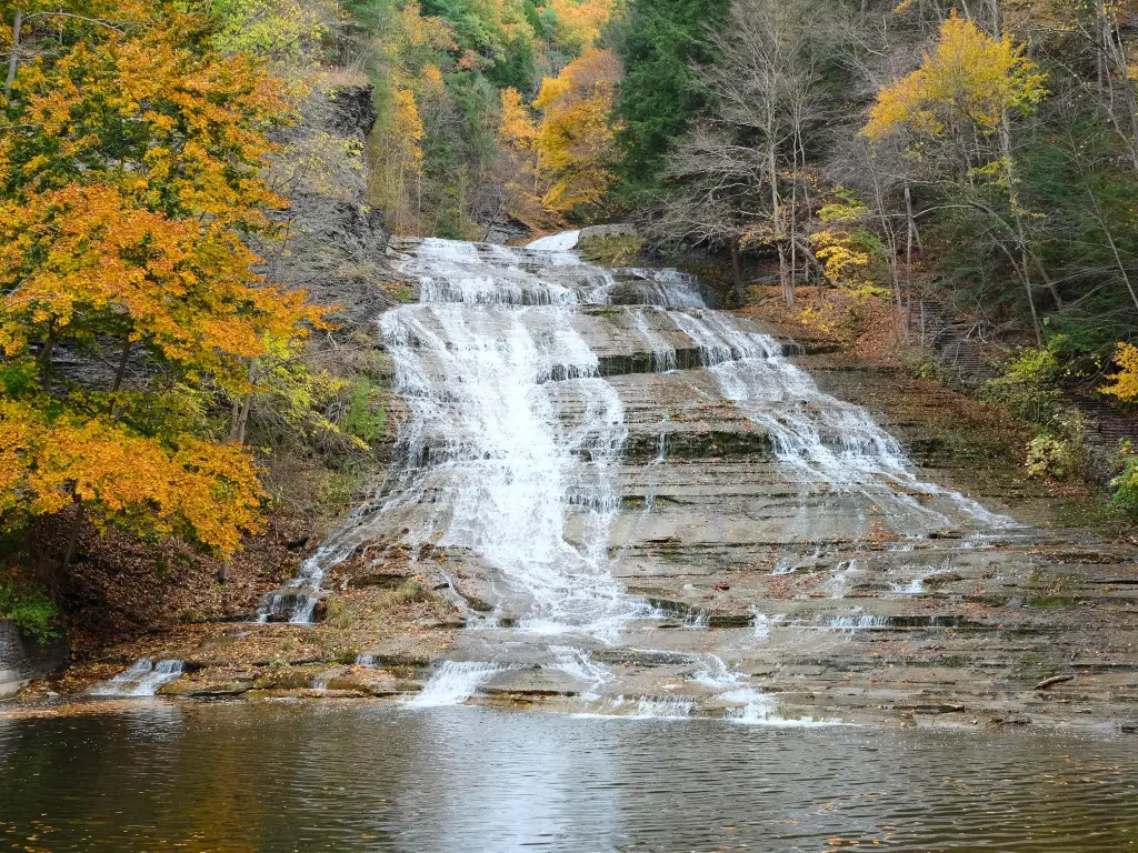 Autumn landscape with beautiful waterfalls on a stone cliff