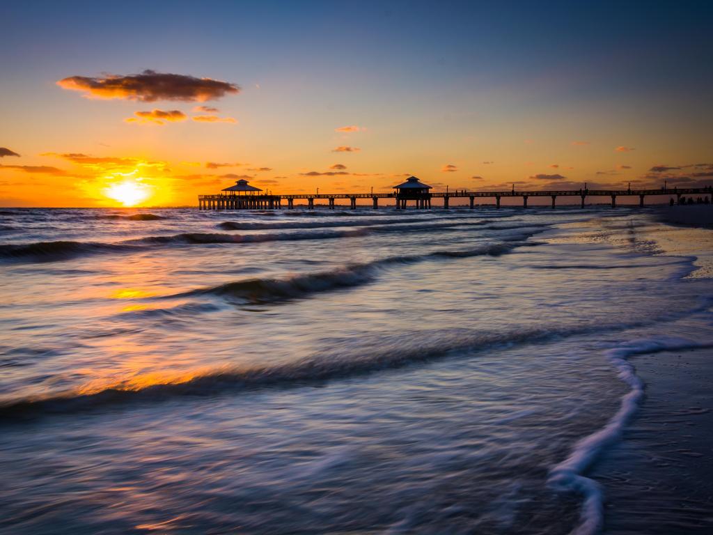 View across the Gulf of Mexico at sunset from a beach in Fort Myers, with light glistening on the water