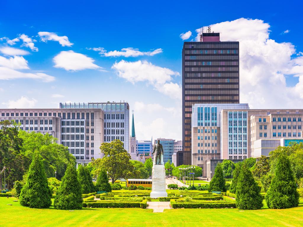 Baton Rouge, Louisiana, USA skyline from Louisiana State Capitol on a sunny day with beautiful landscaped gardens in the foreground.