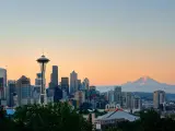 Seattle, Washington, USA with the city skyline with Mt Rainier at sunset with urban office buildings viewed from Kerry Park.