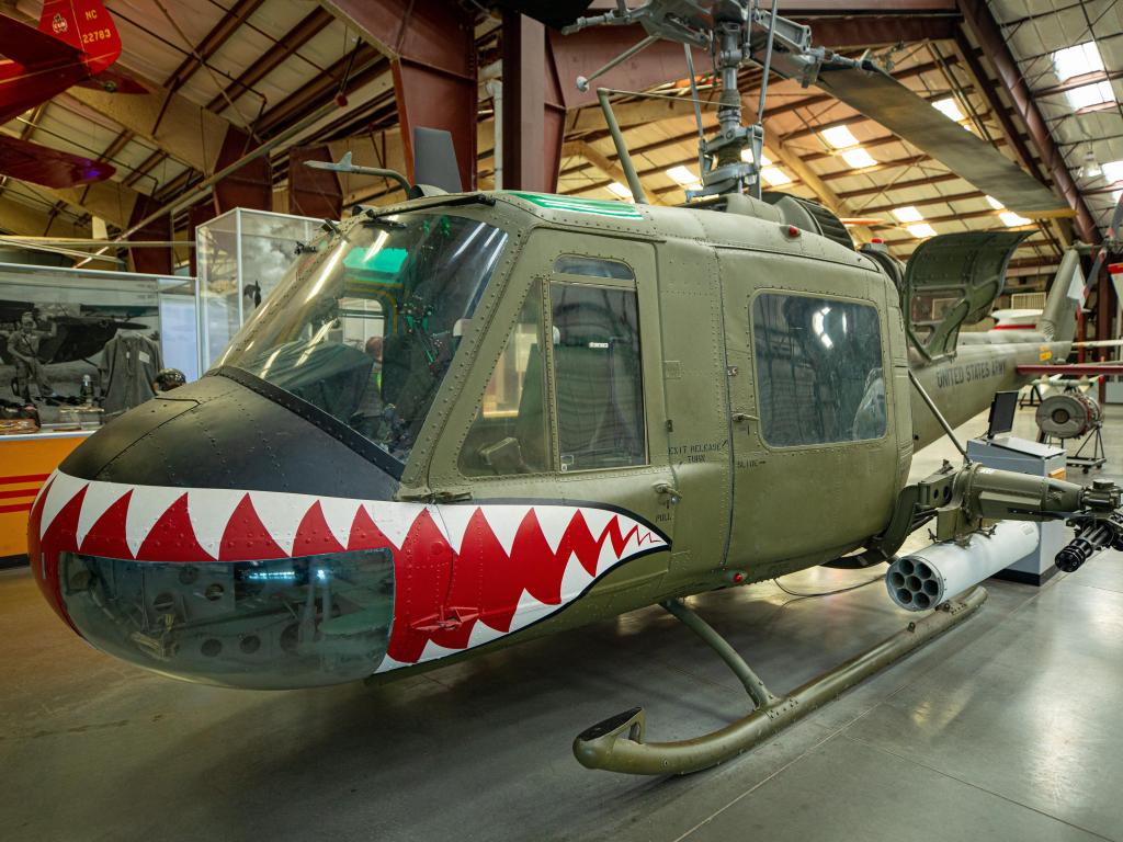 Historic military helicopter with a painted mouth in the museum 