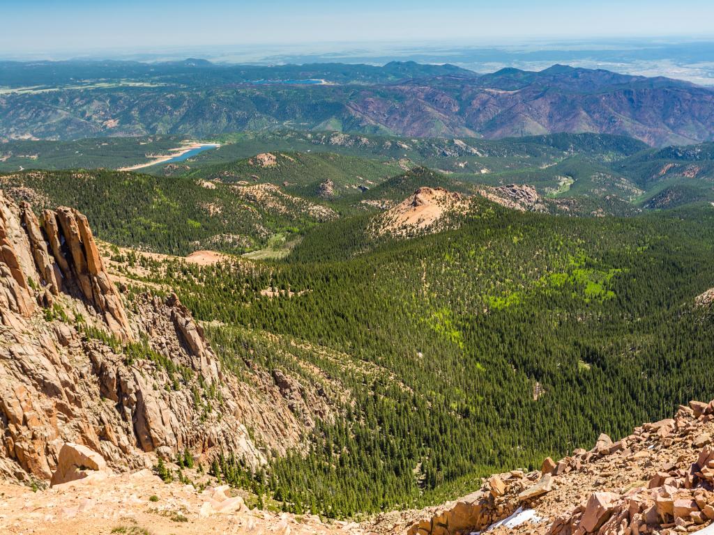 The view from the summit of Pikes Peak onto the forested mountains