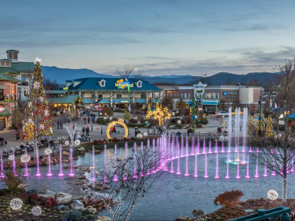 Pigeon Forge, Tennessee, USA with a colorful display from The Island show fountain at early evening.