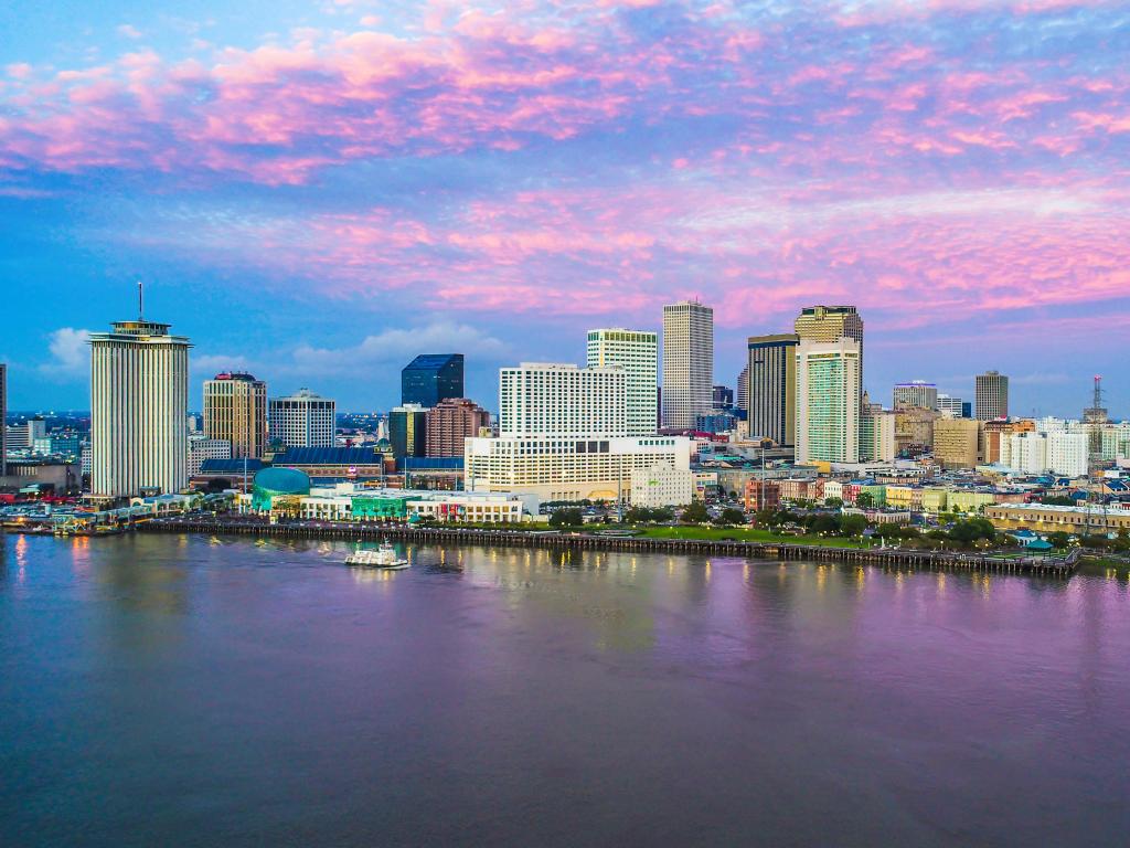 New Orleans, Louisiana, USA with a view of the downtown skyline at sunrise.