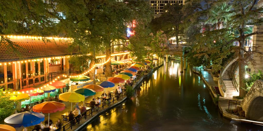 San Antonio Riverwalk by night with people enjoying dinner 