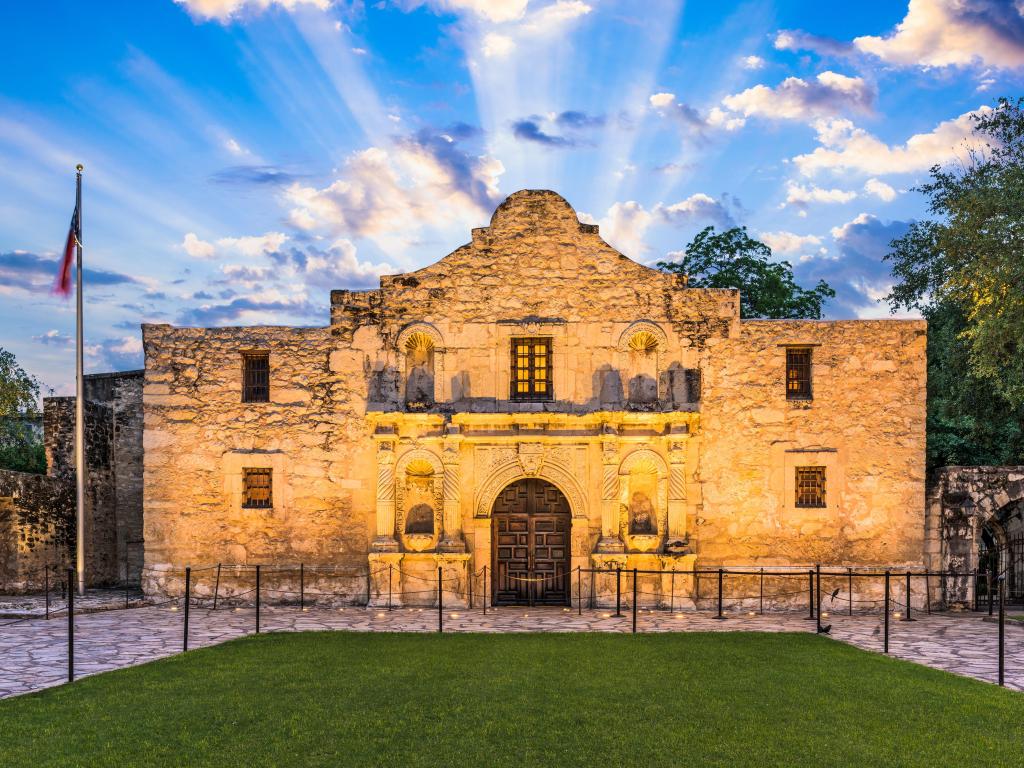 The historic Alamo in San Antonio, photo taken near sunset, with sun beams behind the structure.