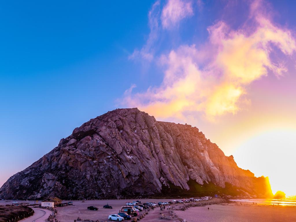Morro Rock at Morro Bay, California at sunset with purple and orange hues in the sky