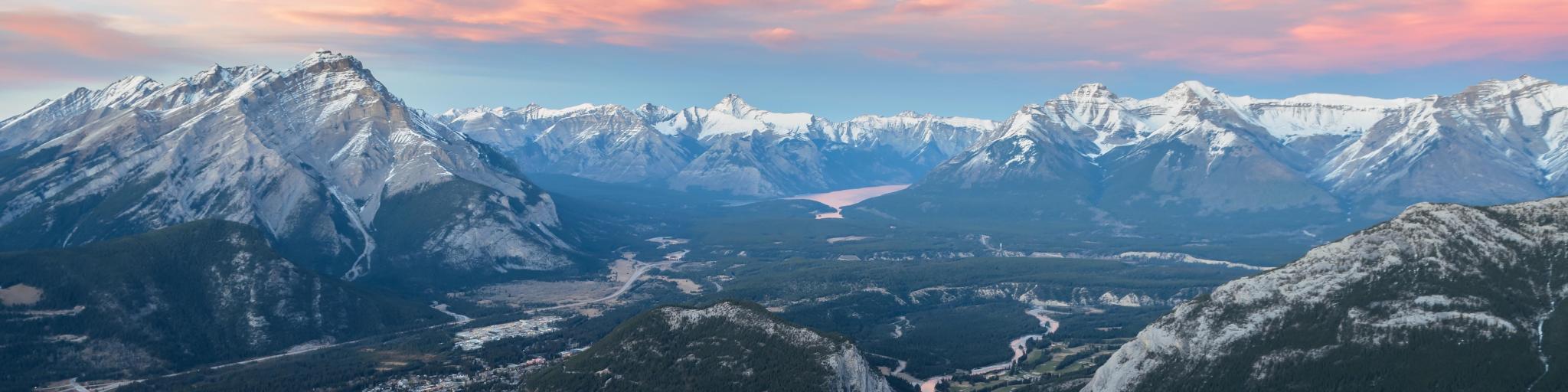 Stunning twilight panoramic view of Bow Valley and Banff town, surrounded by Canadian Rocky mountains. 