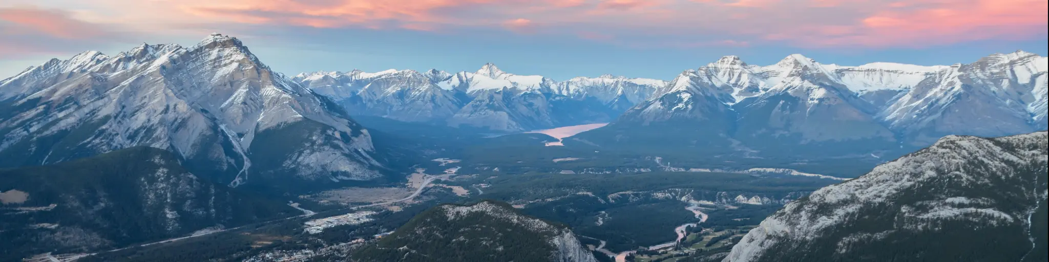 Stunning twilight panoramic view of Bow Valley and Banff town, surrounded by Canadian Rocky mountains. 