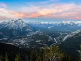 Stunning twilight panoramic view of Bow Valley and Banff town, surrounded by Canadian Rocky mountains. 