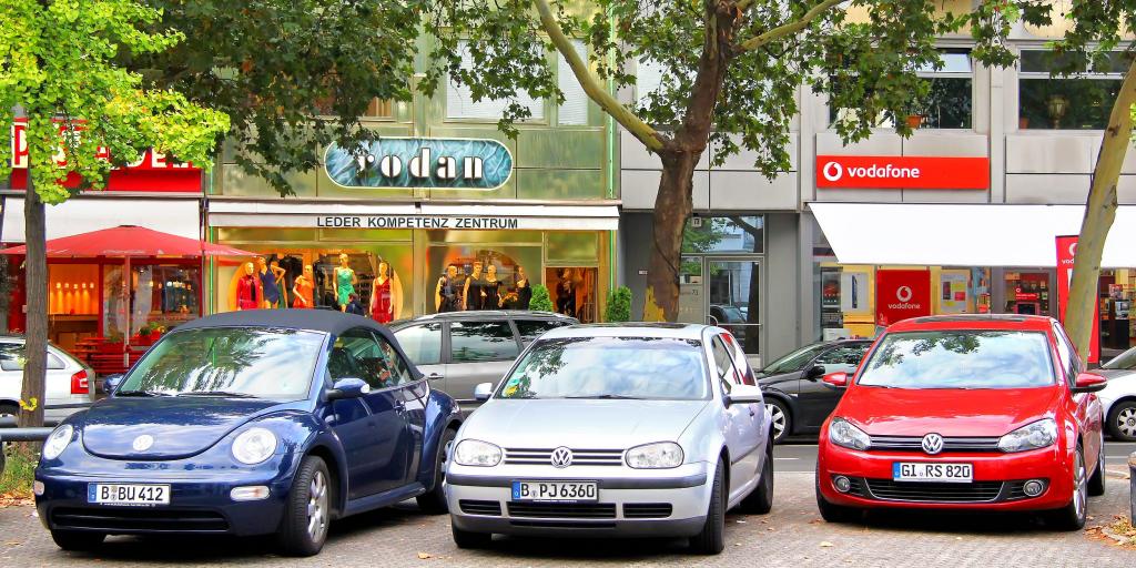 A row of Volkswagen cars parked infront of a shop in Germany