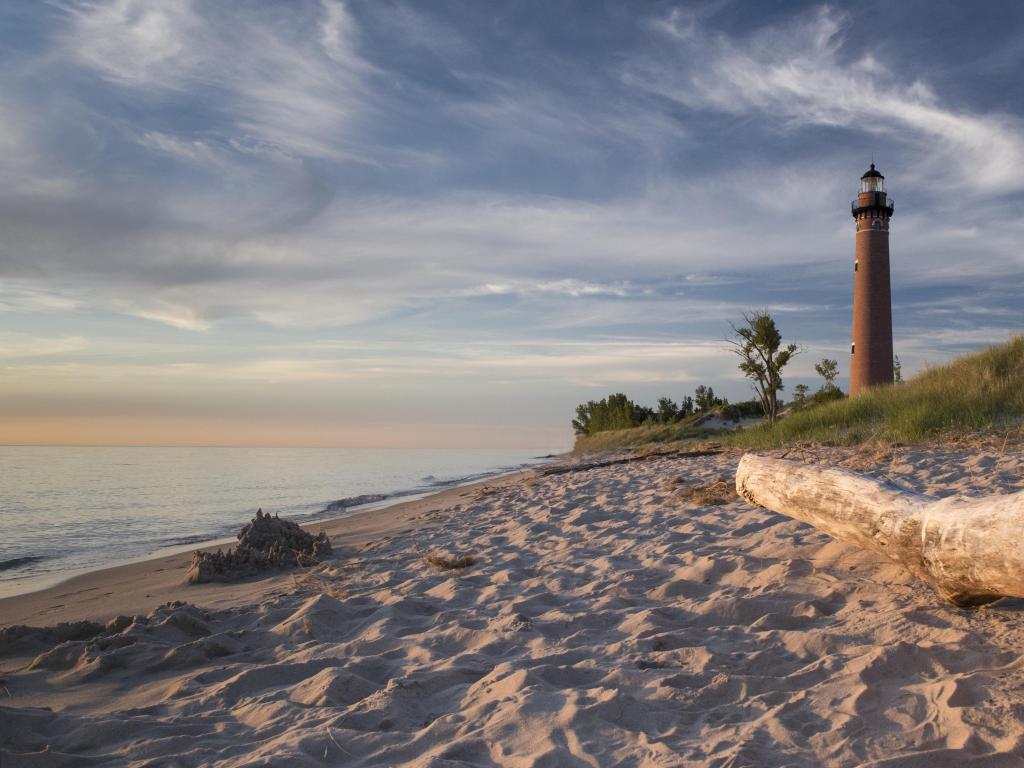 Lake Michigan, USA with a view of Little Sable Lighthouse and white sandy on the shore of the lake taken during early evening.