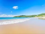 Golden sand on Noosa's Main beach on a clear and sunny day on the Sunshine Coast in Queensland, Australia