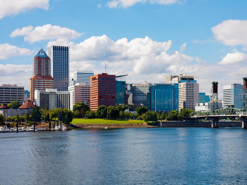Portland, Oregon, USA taken on a sunny day with the city skyline in the distance and the sea in the foreground.