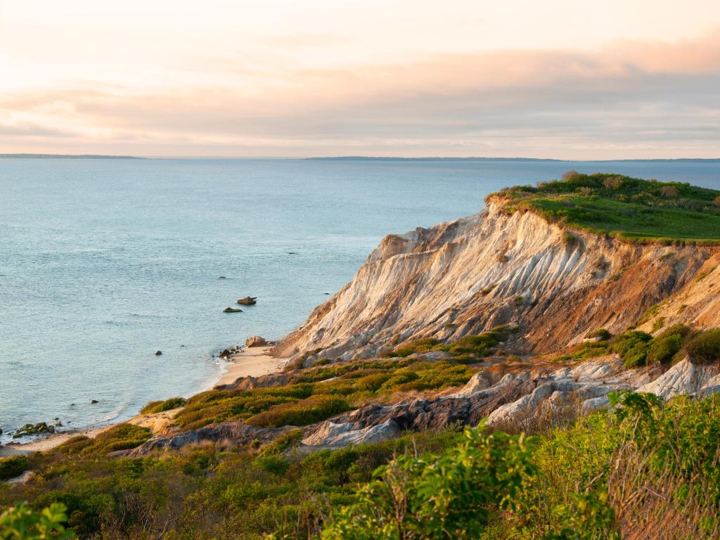 Martha’s Vineyard Island, Massachusetts, USA with the sun sets illuminating the sandy cliffs at Moshup Beach in Aquinnah.