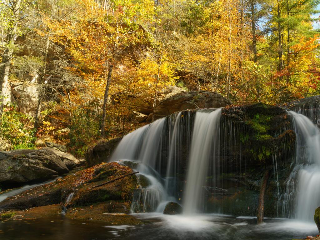 Cherokee National Forest. Appalachian Mountains, Tennessee, USA with Bald River Falls in the foreground, a magical waterfall and surrounded by trees taken at fall on a sunny day.