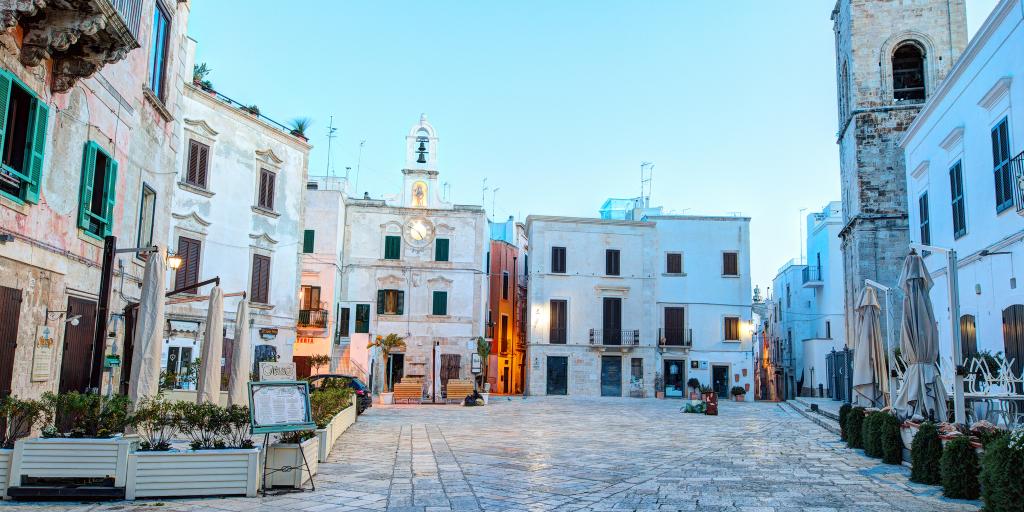 A square lined with white-washed buildings in Polignano a Mare, Puglia 