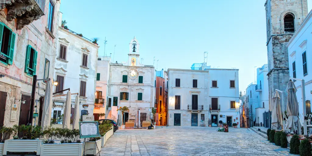 A square lined with white-washed buildings in Polignano a Mare, Puglia 