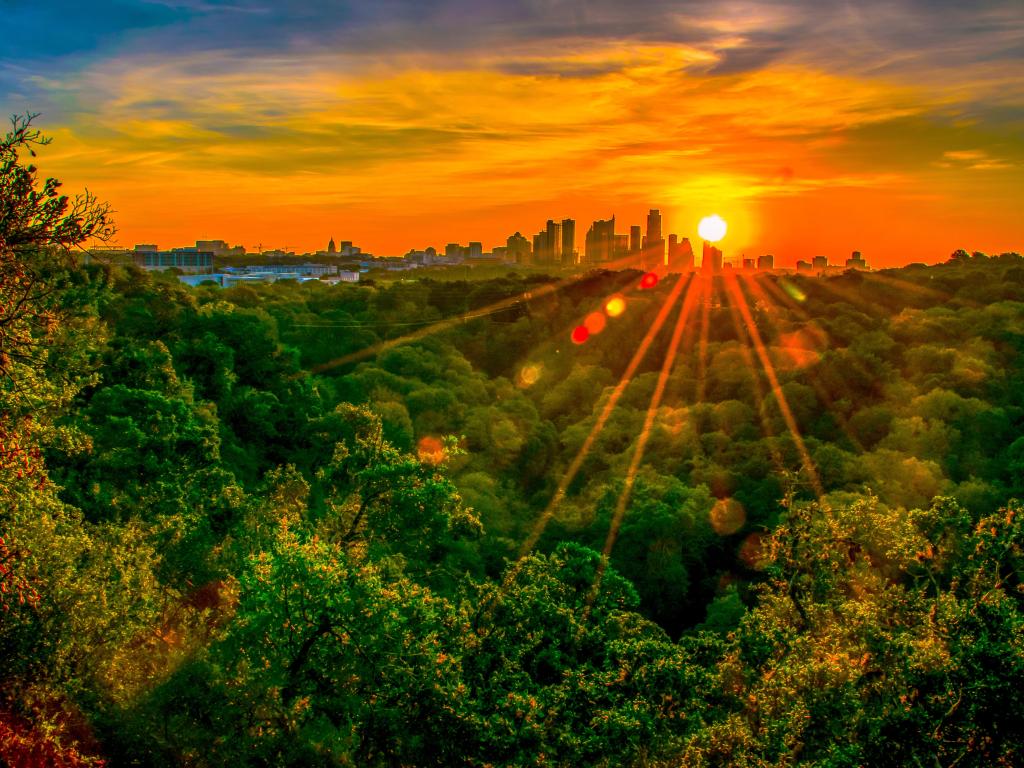 Austin Texas nature trail hiking at sunrise with golden hour sunburst glowing over the city skyline cityscape amazing fine arts photography