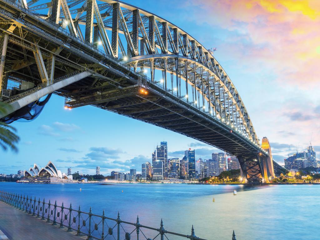 Sydney, Australia with an amazing skyline at dusk and a view under the bridge to the city in the distance. 